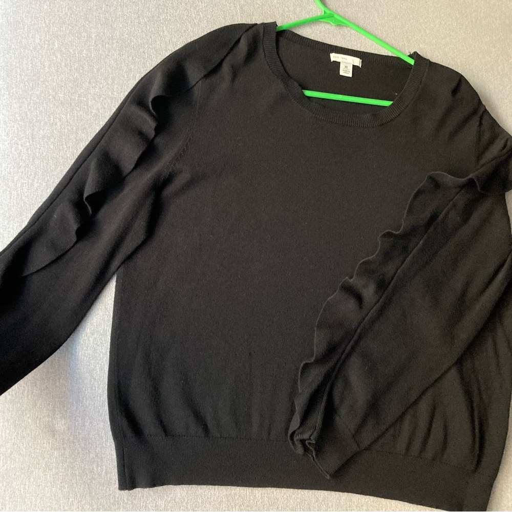 Black long sleeve knit top. Size Xl. Embellished ruffle sleeves.